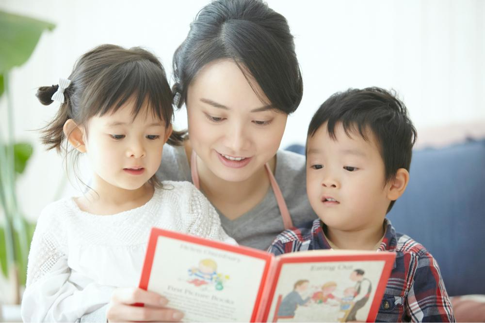 絵本を読む母親と二人の子供